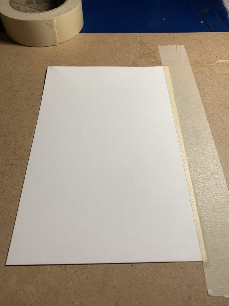White paper taped to a board