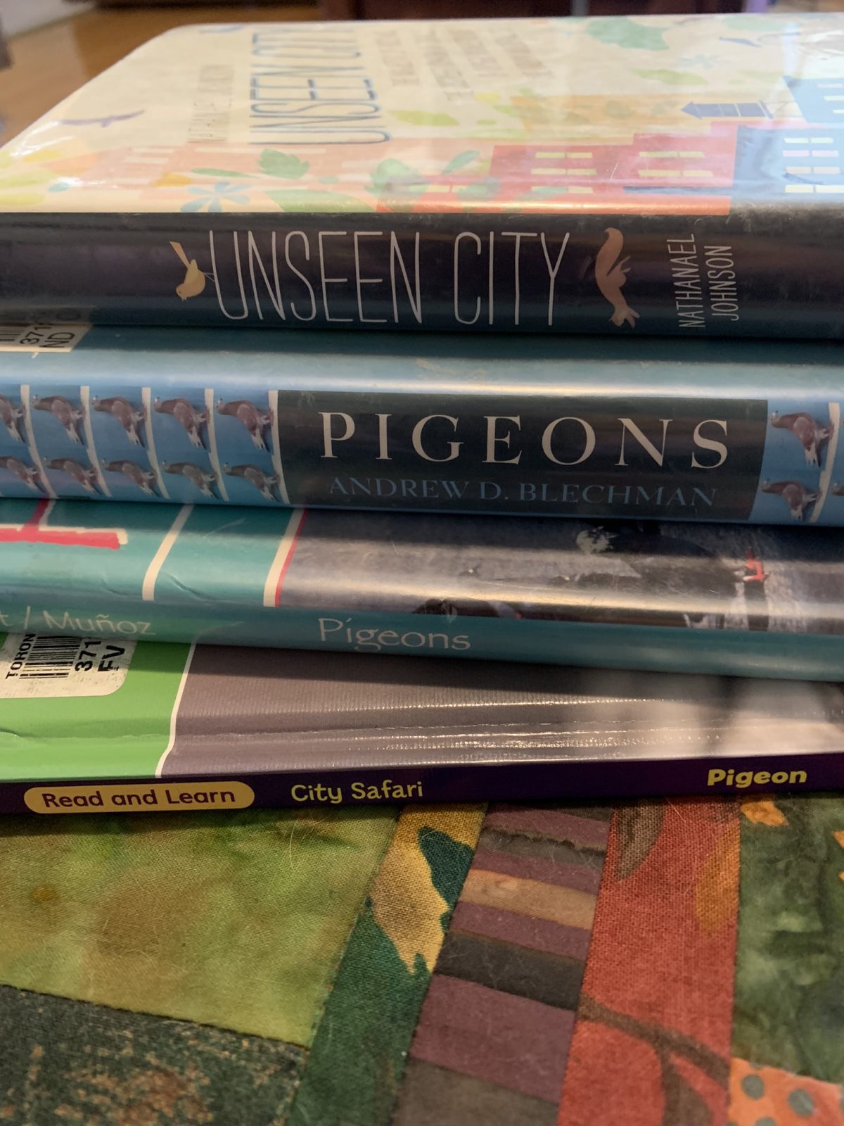 A stack of four books about pigeons