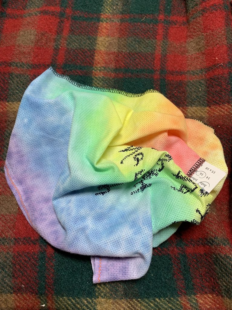 scrunched up rainbow fabric with the back of stitches showing